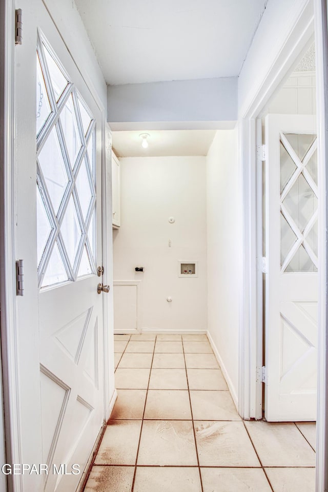 interior space featuring light tile patterned floors and baseboards