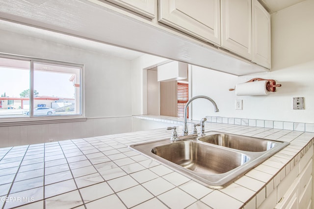 kitchen featuring a sink and tile counters