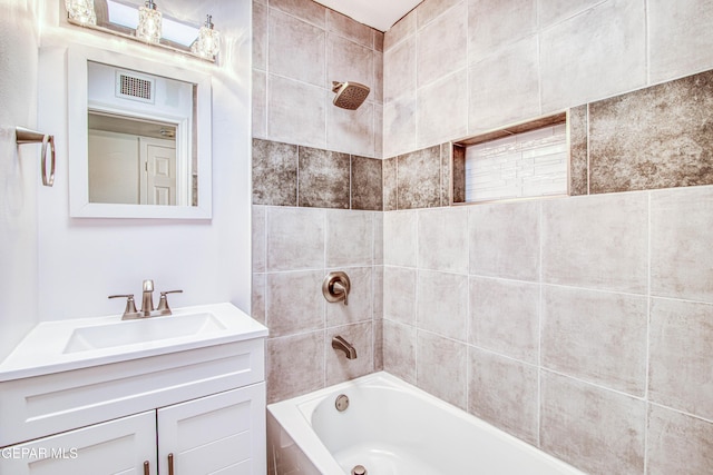 full bathroom with shower / bath combination, vanity, and visible vents