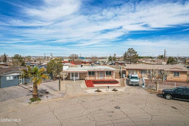 view of front of property featuring a residential view and fence