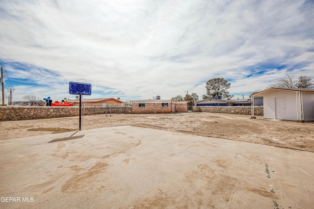 view of yard with a shed, fence, and an outdoor structure