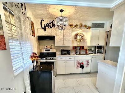 kitchen featuring stainless steel gas stove, a sink, under cabinet range hood, white dishwasher, and light countertops