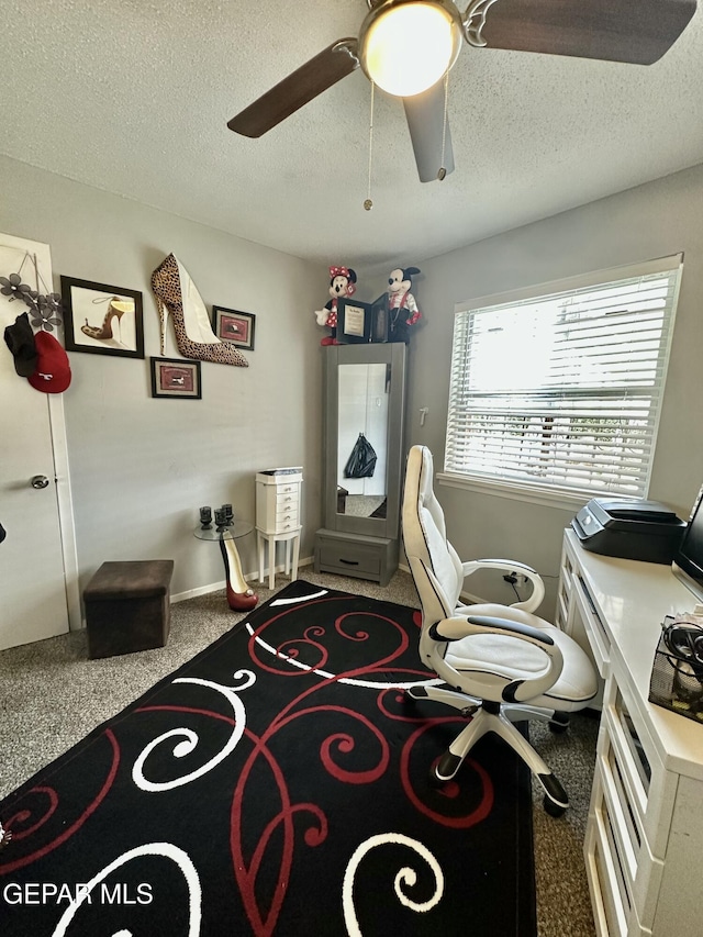 home office with baseboards, a textured ceiling, a ceiling fan, and carpet floors