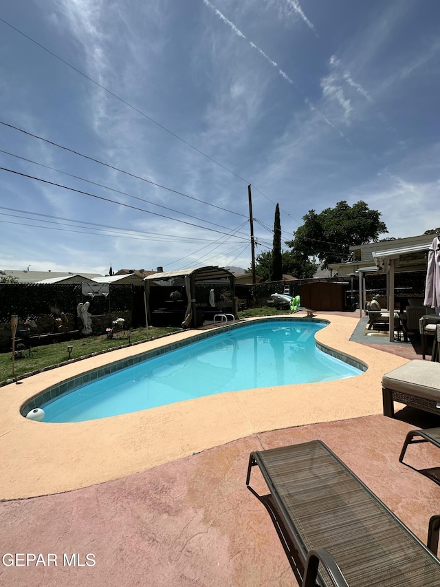 view of pool with a patio, a fenced in pool, and fence