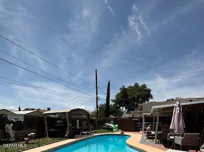 view of pool with a patio area, a fenced in pool, and fence