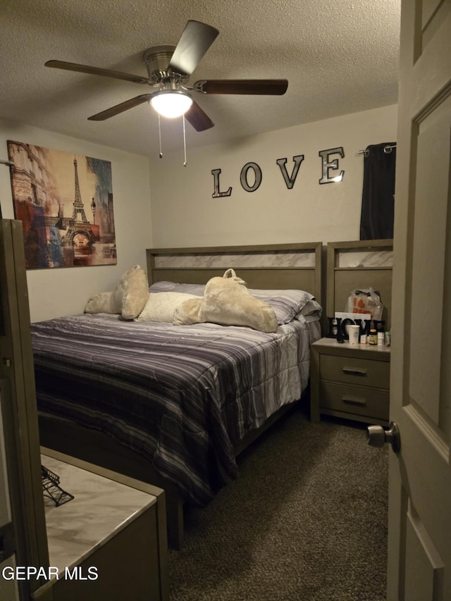 carpeted bedroom featuring a textured ceiling and ceiling fan