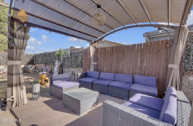 view of patio featuring outdoor lounge area and fence