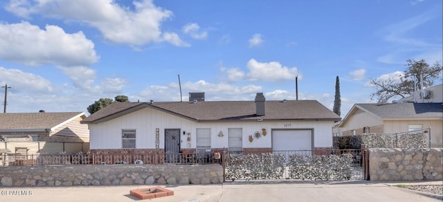 ranch-style home featuring a fenced front yard, a chimney, and a garage