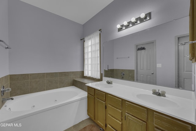 full bathroom featuring a sink, a jetted tub, and double vanity