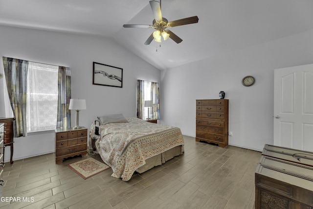 bedroom with lofted ceiling, a ceiling fan, and wood finish floors