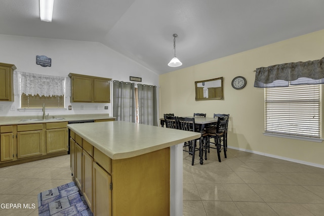 kitchen with light tile patterned flooring, vaulted ceiling, light countertops, and a sink