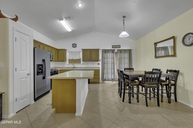 kitchen featuring visible vents, stainless steel refrigerator with ice dispenser, a sink, light countertops, and vaulted ceiling