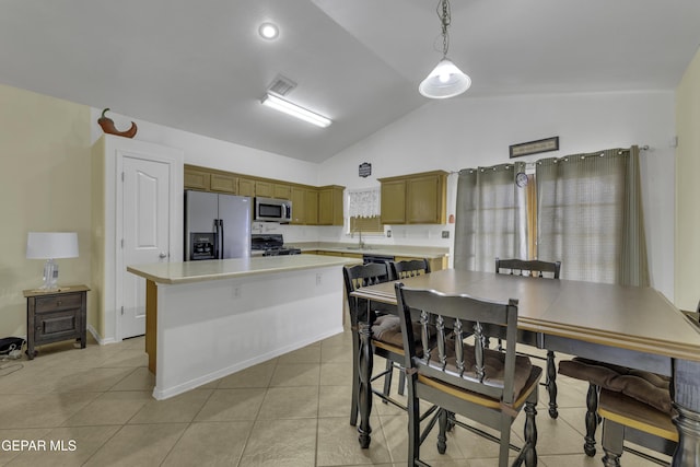 kitchen featuring light tile patterned floors, a kitchen island, a sink, black appliances, and light countertops