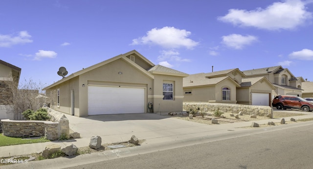 ranch-style house with stucco siding, a garage, and concrete driveway