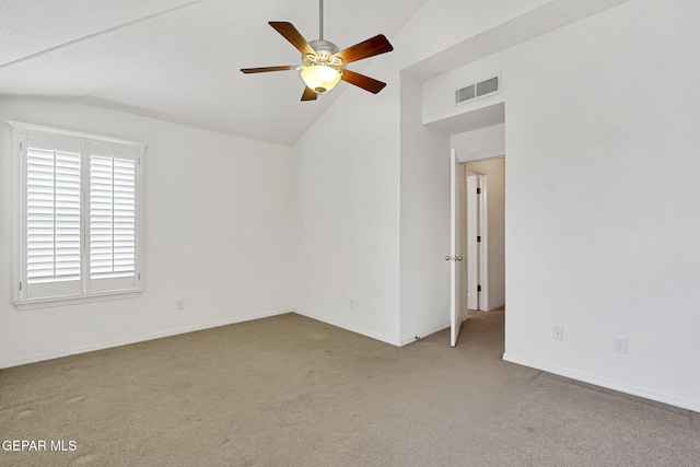 carpeted spare room featuring visible vents, lofted ceiling, baseboards, and a ceiling fan