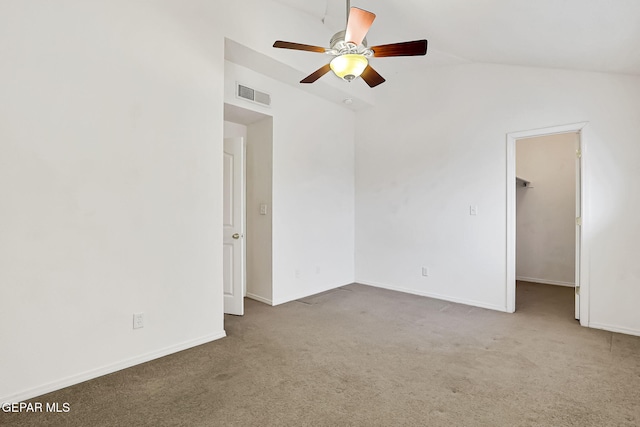 empty room with a ceiling fan, visible vents, baseboards, lofted ceiling, and carpet flooring