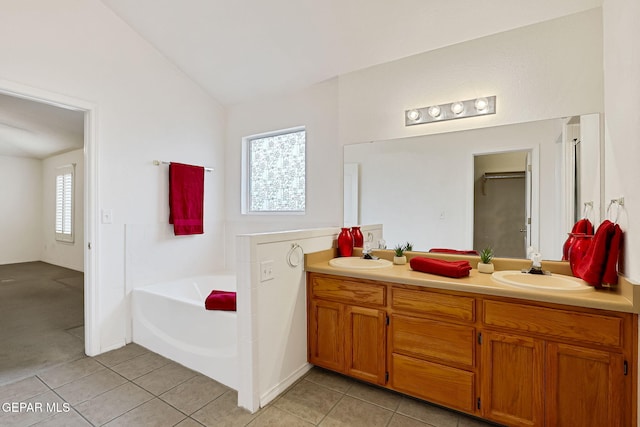 full bath featuring a sink, tile patterned flooring, double vanity, lofted ceiling, and a bath