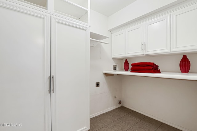 laundry room with cabinet space, light tile patterned floors, baseboards, hookup for an electric dryer, and hookup for a washing machine