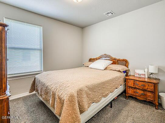 bedroom featuring carpet floors, baseboards, and visible vents