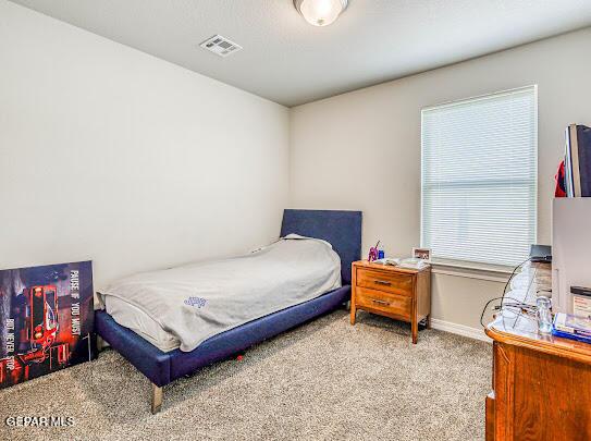 bedroom featuring carpet flooring, visible vents, and baseboards