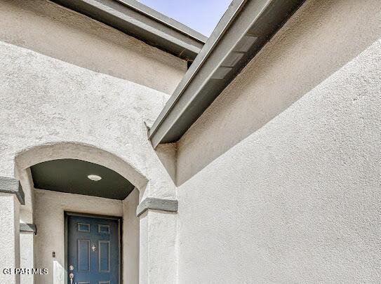 details with arched walkways and stucco siding