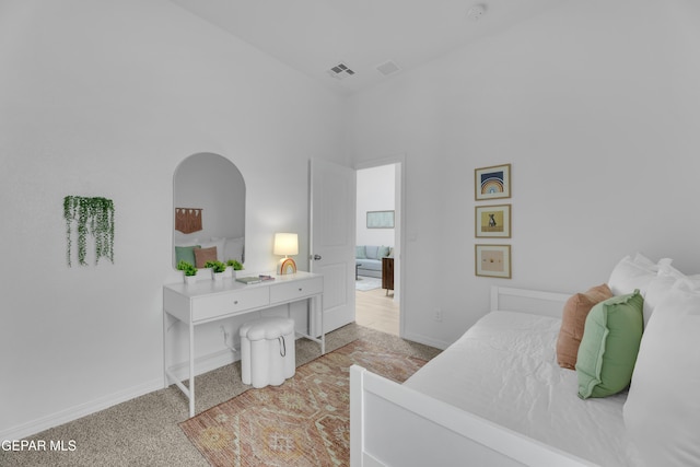 bedroom featuring light colored carpet, visible vents, and baseboards