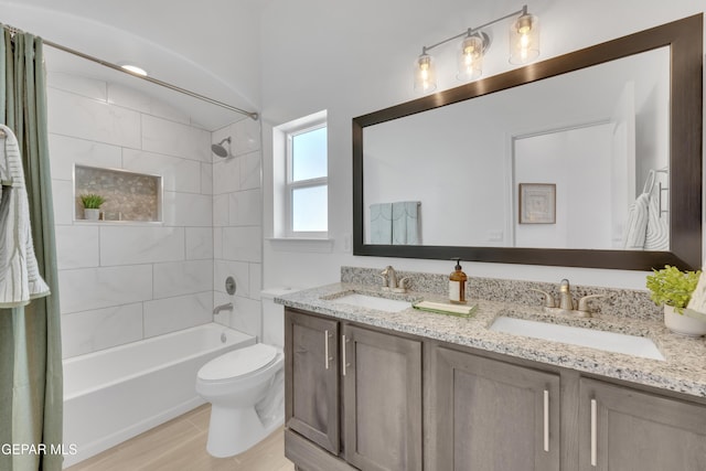 bathroom with toilet, double vanity, a sink, and shower / tub combo with curtain