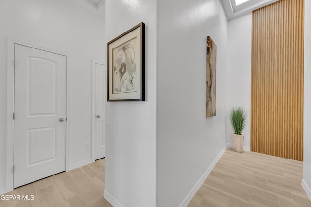 corridor with wood finish floors and baseboards