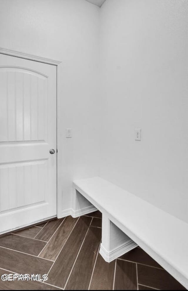 mudroom featuring wood finish floors and baseboards