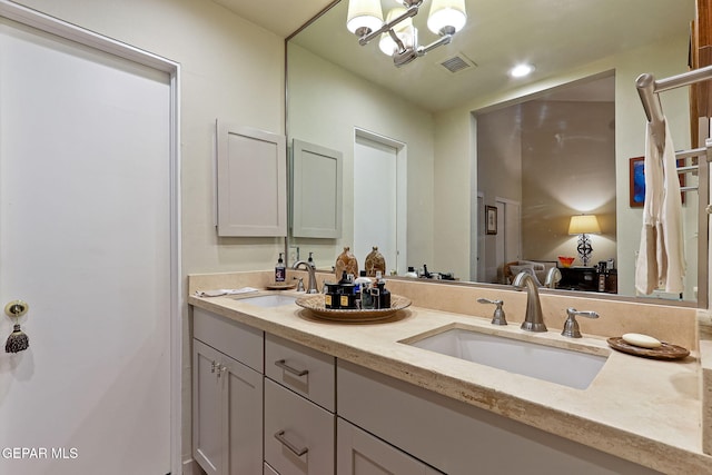 bathroom with double vanity, a sink, visible vents, and recessed lighting