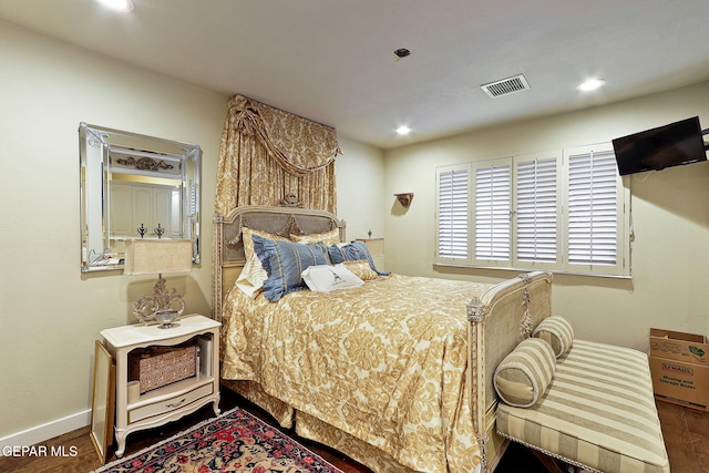 bedroom featuring baseboards, wood finished floors, visible vents, and recessed lighting