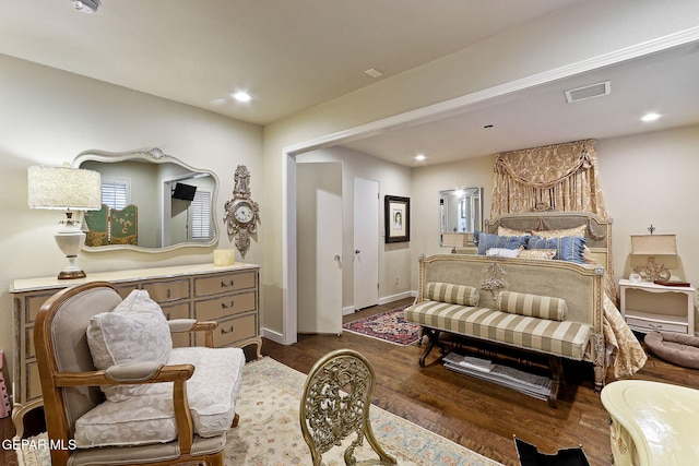 bedroom featuring baseboards, dark wood finished floors, visible vents, and recessed lighting