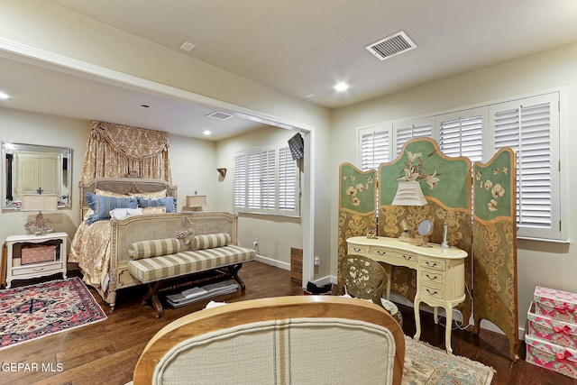 bedroom with recessed lighting, visible vents, baseboards, and wood finished floors