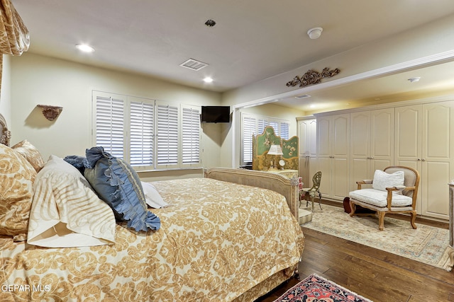 bedroom with visible vents, dark wood-type flooring, and recessed lighting