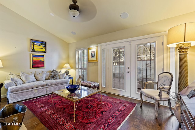 living room with a wealth of natural light, wood-type flooring, vaulted ceiling, and french doors