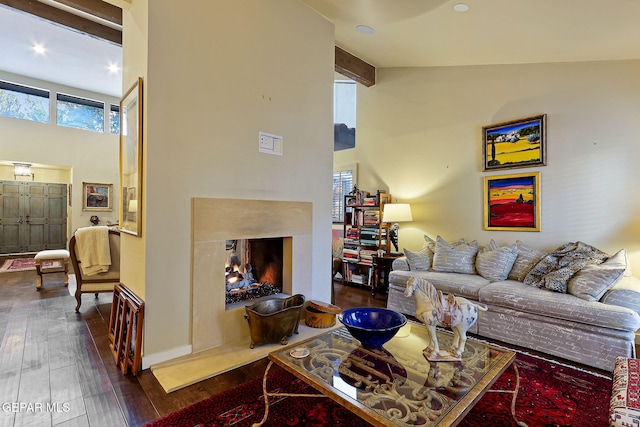 living area featuring beam ceiling, high vaulted ceiling, hardwood / wood-style floors, and a multi sided fireplace