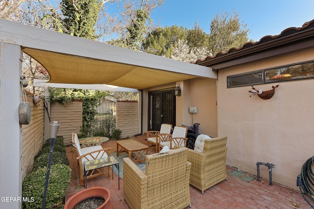 view of patio featuring fence and an outdoor hangout area