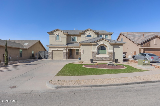 view of front of home with concrete driveway, stone siding, a tile roof, an attached garage, and stucco siding