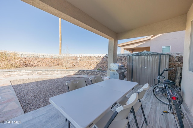 view of patio / terrace featuring outdoor dining area and a grill