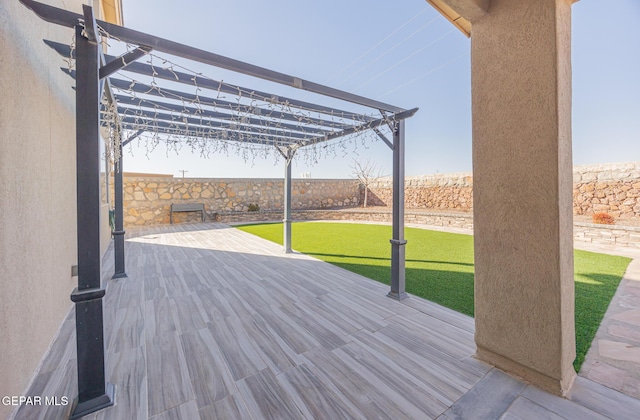 deck featuring fence, a pergola, and a yard