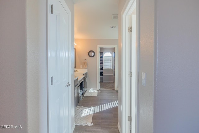 bathroom with wood finish floors, visible vents, and vanity