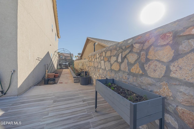 deck featuring a garden and fence