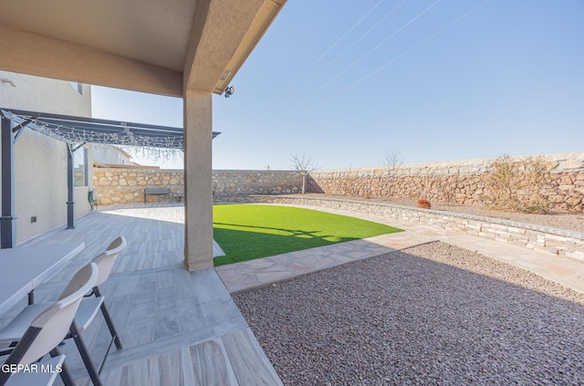 view of yard with a patio area, a fenced backyard, and a pergola