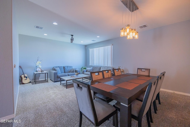 dining space with carpet flooring, visible vents, and baseboards