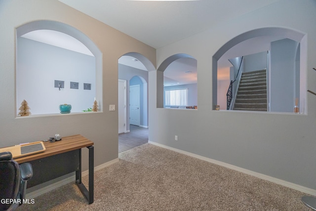 carpeted office featuring baseboards