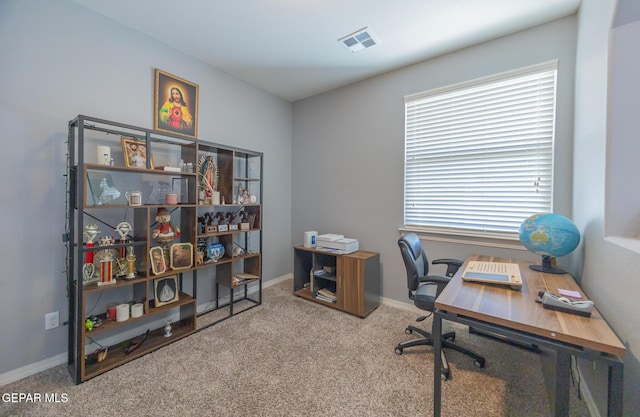 carpeted office featuring visible vents and baseboards