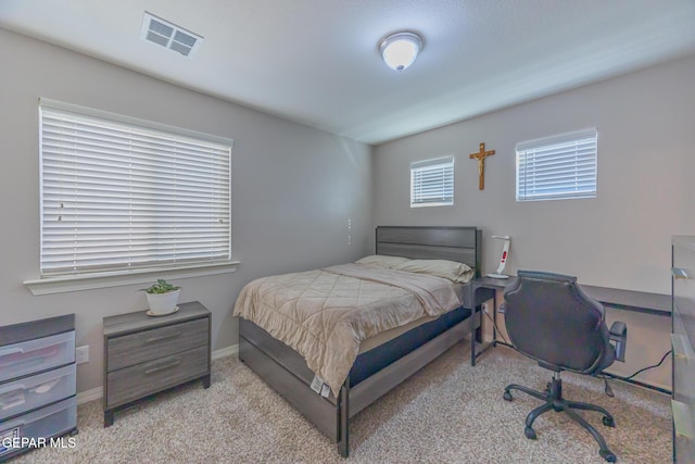 bedroom with baseboards, visible vents, and carpet flooring