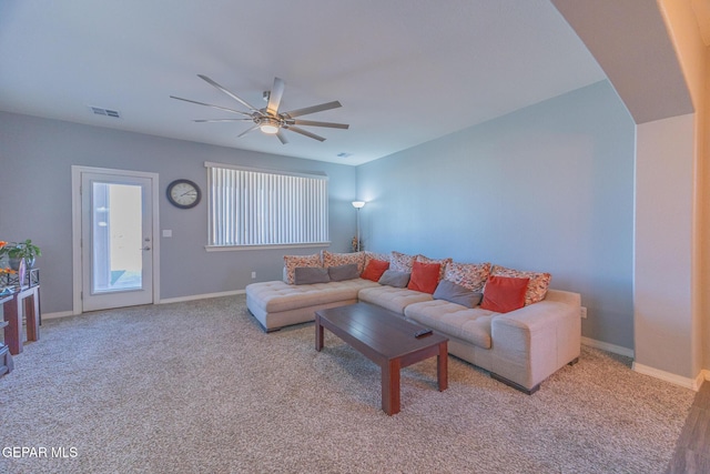 carpeted living room featuring ceiling fan, visible vents, and baseboards