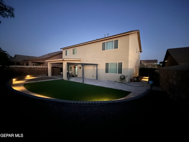 back of property with a patio, fence, and stucco siding