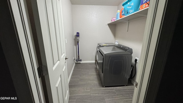 laundry area featuring laundry area, baseboards, dark wood-style flooring, and washer and dryer